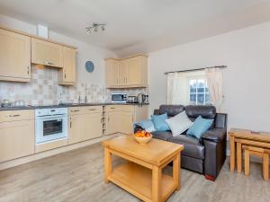 a living room with a couch and a table at Harbour View in Cromarty