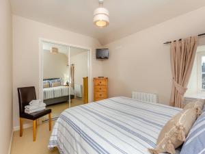 a bedroom with a bed and a mirror at Harbour View in Cromarty +11 photos