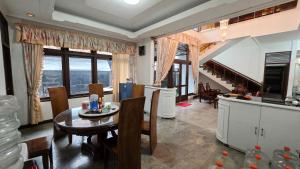 a kitchen and living room with a table and chairs at Rumah Mewah Johar in Pontianak