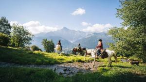 a group of people riding horses near a river at Relax alpino con sauna - Ca da Viola in Cavagnago