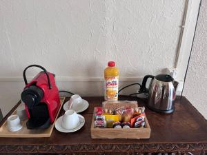 a table with a toaster a coffee maker and a tea kettle at La Halte Louis XIII in Bram +7 photos