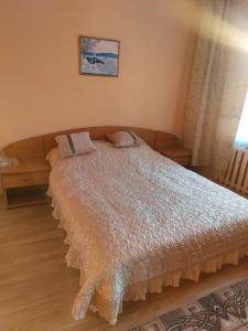 a bedroom with a large bed in a room at Butas in Gaveikėnai