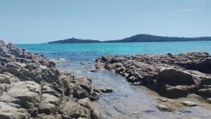 a group of rocks on the shore of the ocean at charmante maisonnette avec spa privatif in Zonza