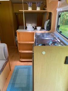 a kitchen in the back of an rv at Karavan Pod Lipami in Dolní Bečva