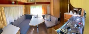 a small room with a couch and a table in a caravan at Karavan Pod Lipami in Dolní Bečva