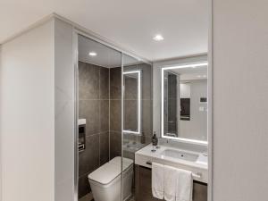 a bathroom with a toilet and a sink and a mirror at 센텀 뉴시즈 호텔 in Millak-tong +19 photos