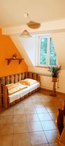 a bedroom with a bed in a room with a window at Dworek Myśliwski in Łaziska