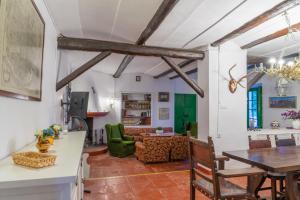 a living room with a table and a couch at Cortijo el Vicario in Ronda