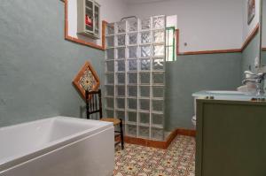 a bathroom with a tub and a sink at Cortijo el Vicario in Ronda +13 photos