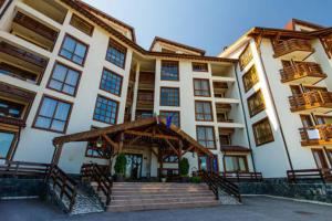 a large building with stairs in front of it at One-Bedroom Apartment with Balcony & Fast WiFi in Bansko