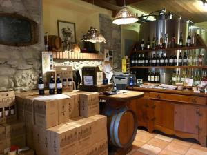 a bar with boxes of wine in a room at Agriturismo Le Caldane in Colà di Lazise +43 photos