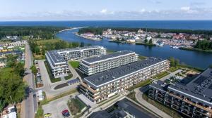 an aerial view of a city with a river and buildings at Raspberry apartment and SPA in Dziwnów