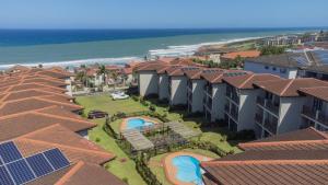 an aerial view of a resort with solar panels on the roofs at 7 Topanga in Uvongo Beach
