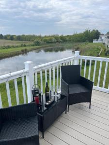a deck with two chairs and a bottle of wine at Lucys Pad in Hull