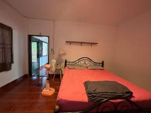 a bedroom with a bed with a red comforter at Honey Zen Zone in Ko Mak +11 photos