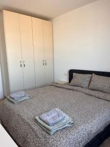 a bedroom with a bed with two towels on it at Confort Suite in Alba Iulia