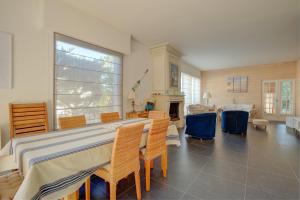 a living room with a table and chairs and a fireplace at Maison des Abatilles- Bassin Arcachon in Arcachon +10 photos
