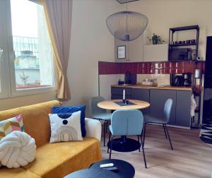 a living room with a couch and a table and a kitchen at Buda's Hidden Heaven 1 with Private Sauna in Budapest