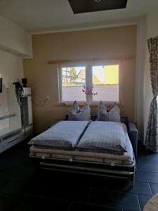 a bedroom with a large bed with a window at Casa Mia in Goslar