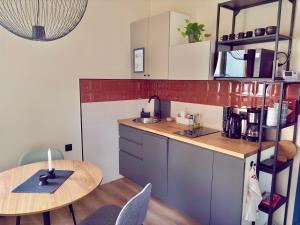 a small kitchen with a table and a table and a dining room at Buda's Hidden Heaven 1 with Private Sauna in Budapest +14 photos