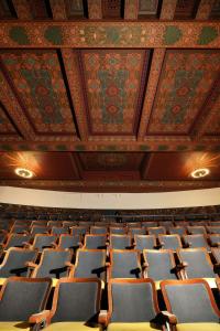 an auditorium with rows of chairs and a ceiling at AC Hotel Detroit at the Bonstelle in Detroit