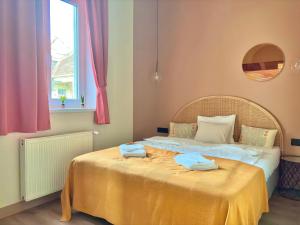 a bedroom with a bed with two towels on it at Buda's Hidden Heaven 1 with Private Sauna in Budapest