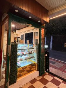 a store front with a refrigerator with food in it at Hotel white lion-Near Bhajra Taxi Stand in Gangtok