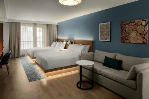 a hotel room with a bed and a couch at Element by Marriott Seattle Downtown in Seattle +39 photos