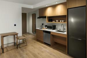a kitchen with a black refrigerator and a sink at Element by Marriott Seattle Downtown in Seattle