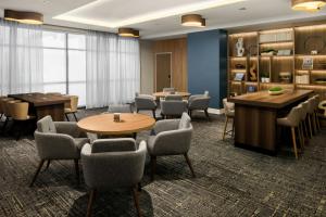 a waiting room with tables and chairs and a library at Element by Marriott Seattle Downtown in Seattle