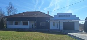 a blue and white house with a garage at Vila Marjanovic PN in Paraćin