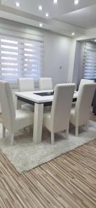a conference room with a table and white chairs at Vila Marjanovic PN in Paraćin