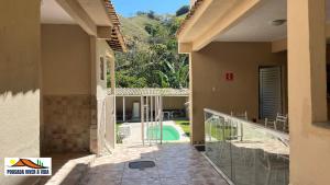 a balcony of a house with a swimming pool at Ninho do Vale - Centro Conservatória in Conservatória