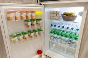 an open refrigerator filled with drinks and juice at 4 Rent di Cicchinelli Lorella in Albano Laziale