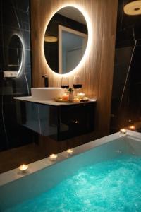 a bathroom with a tub and a sink and a mirror at Romantic Sea View Studio with Jacuzzi in Alicante Center in Alicante +12 photos