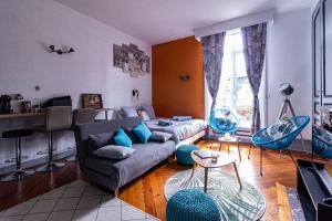 a living room with a couch and a table at La Villa in Rouen