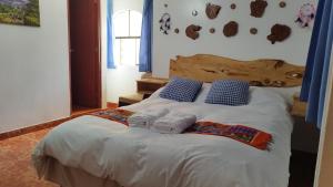 a bedroom with a bed with towels on it at casa hostel vacahouse Huaraz in Huaraz
