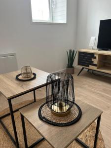 a living room with a table and a chair at Joli T2 proche parc expo in Mulhouse