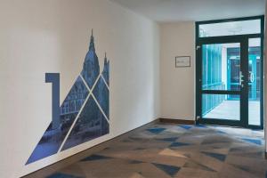 a room with a picture of a building on the wall at Four Points Flex by Sheraton Hannover in Hannover