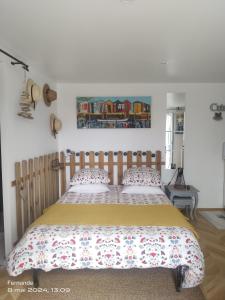 a bedroom with a wooden bed with two pillows at Studio CAP à CAP in Mimizan