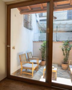 a patio with two chairs and a table on a balcony at Guest house IL VICOLO in Caprarola +16 photos