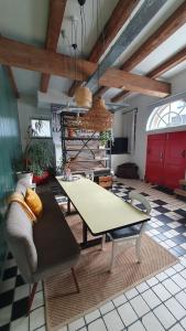a living room with a table and a couch at Het Pakhuis Schiedam in Schiedam