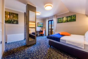 a hotel room with a bed and a mirror at Hotel Bitoraj Fužine in Fužine +135 photos