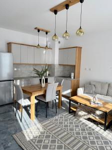 a kitchen and dining room with a table and a couch at Apartament Stare Miasto 2 in Elblag