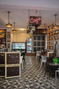 a restaurant with a cafe sign and tables and chairs at Stanza Premium Hotels in Bhubaneshwar