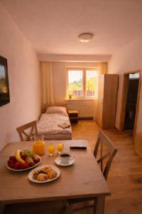 a room with a table with plates of food on it at Pohoda Stay in Revúca