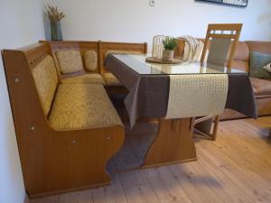 a dining room table with a couch and a table and chairs at Pauza Plac in Žitence