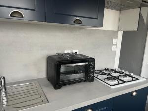 a toaster oven sitting on a counter in a kitchen at Gîte au Petit Café in Châteauvillain