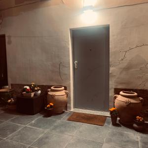 a room with two large vases next to a door at Oasi di pace in Romano Canavese +19 photos