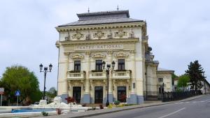 a large white building with a sign on it at Ultracentral Biblioteca in Caracal